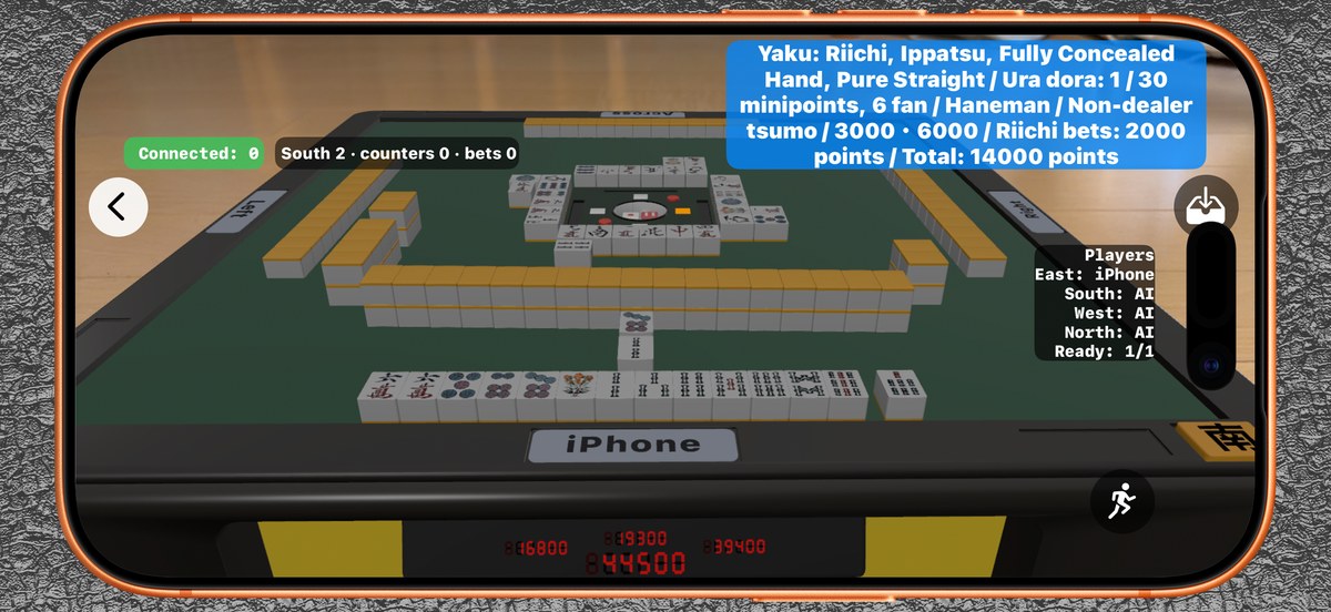 The AR mahjong table seen on an iPhone, standing on a real table, with the winning hand summarised at the top of the screen